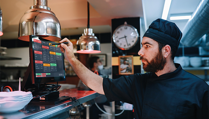 Chef using TouchKitchen in kitchen